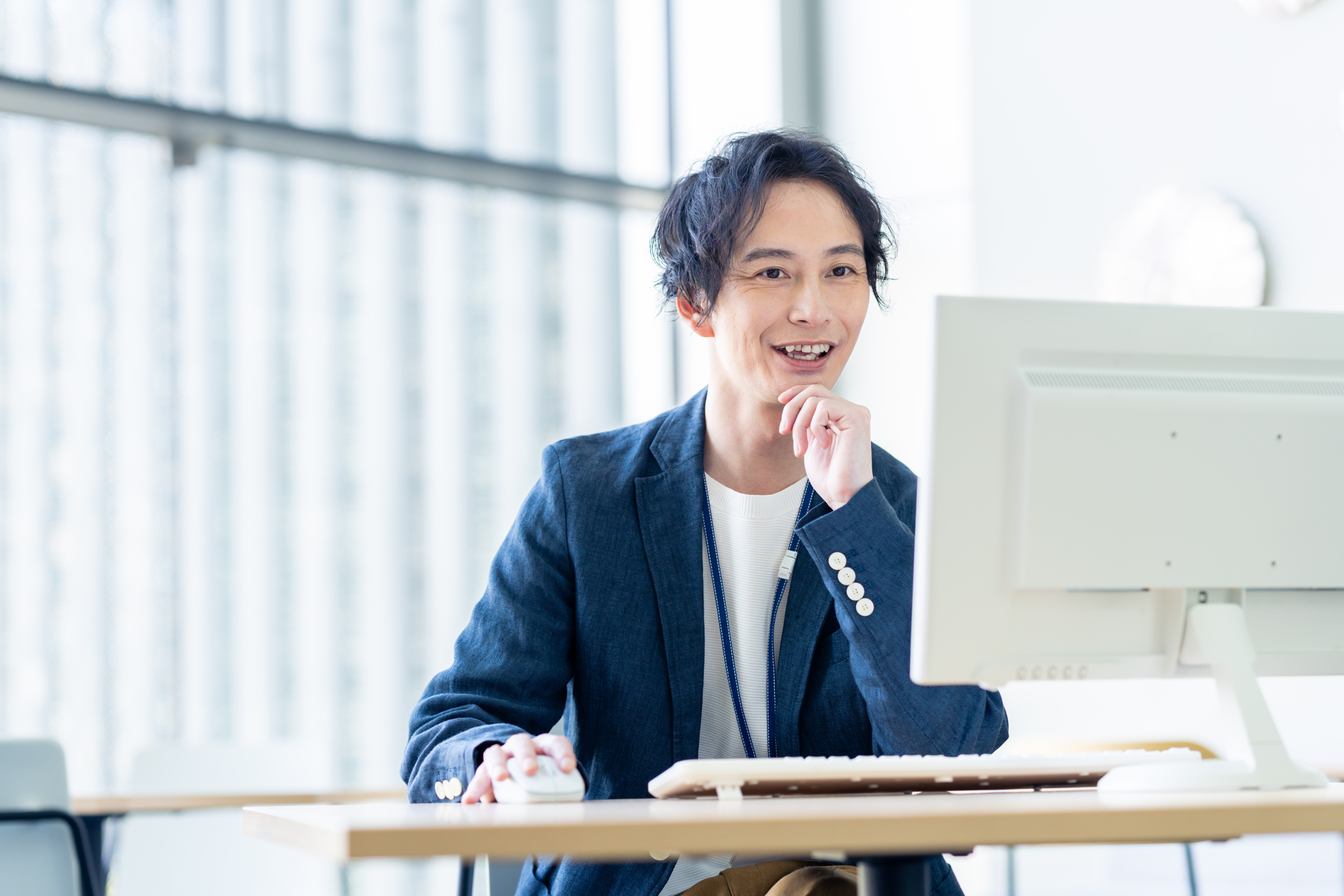 男性が笑顔で仕事をしている様子の写真